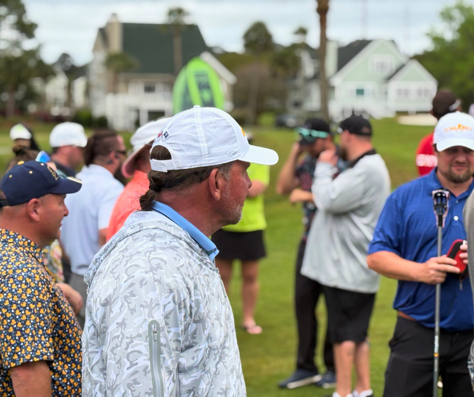 Spectators gathered near the 18th green during the Lowcountry Open at Old South Golf Links, with General Manager Scott Adams in the foreground.